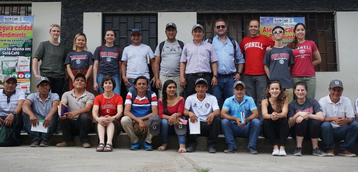 Students, cooperative members and farmers gather together for photo.